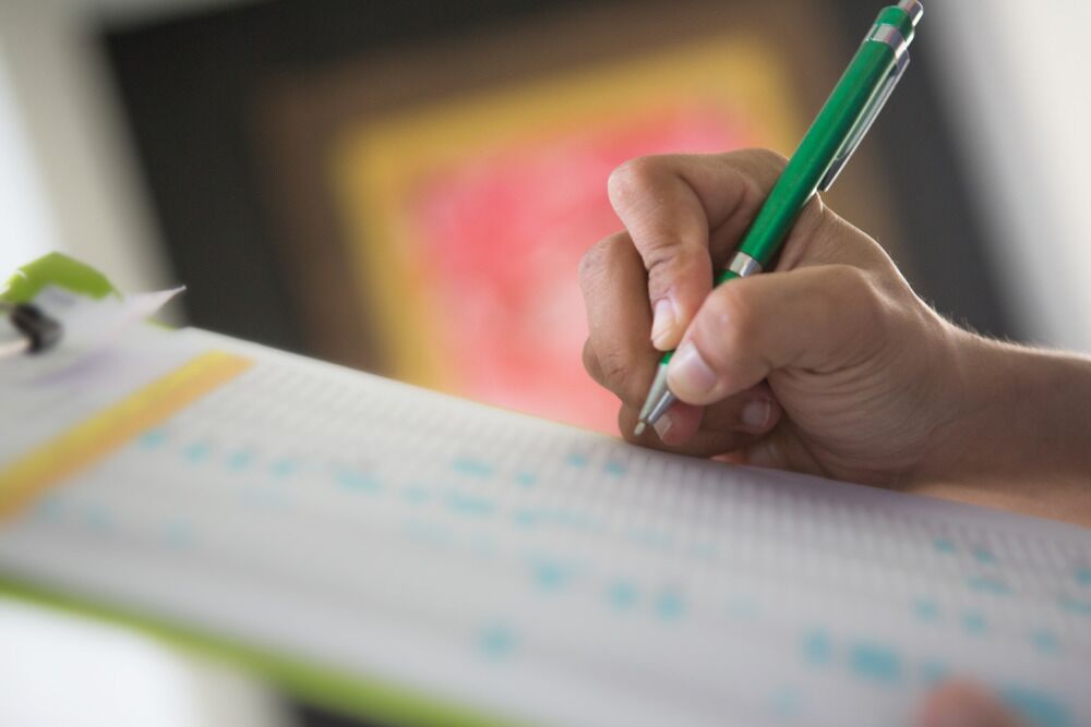 The Better Home Security Checklist - 1000x667 The Better Home Security Checklist - person marking down items on checklist